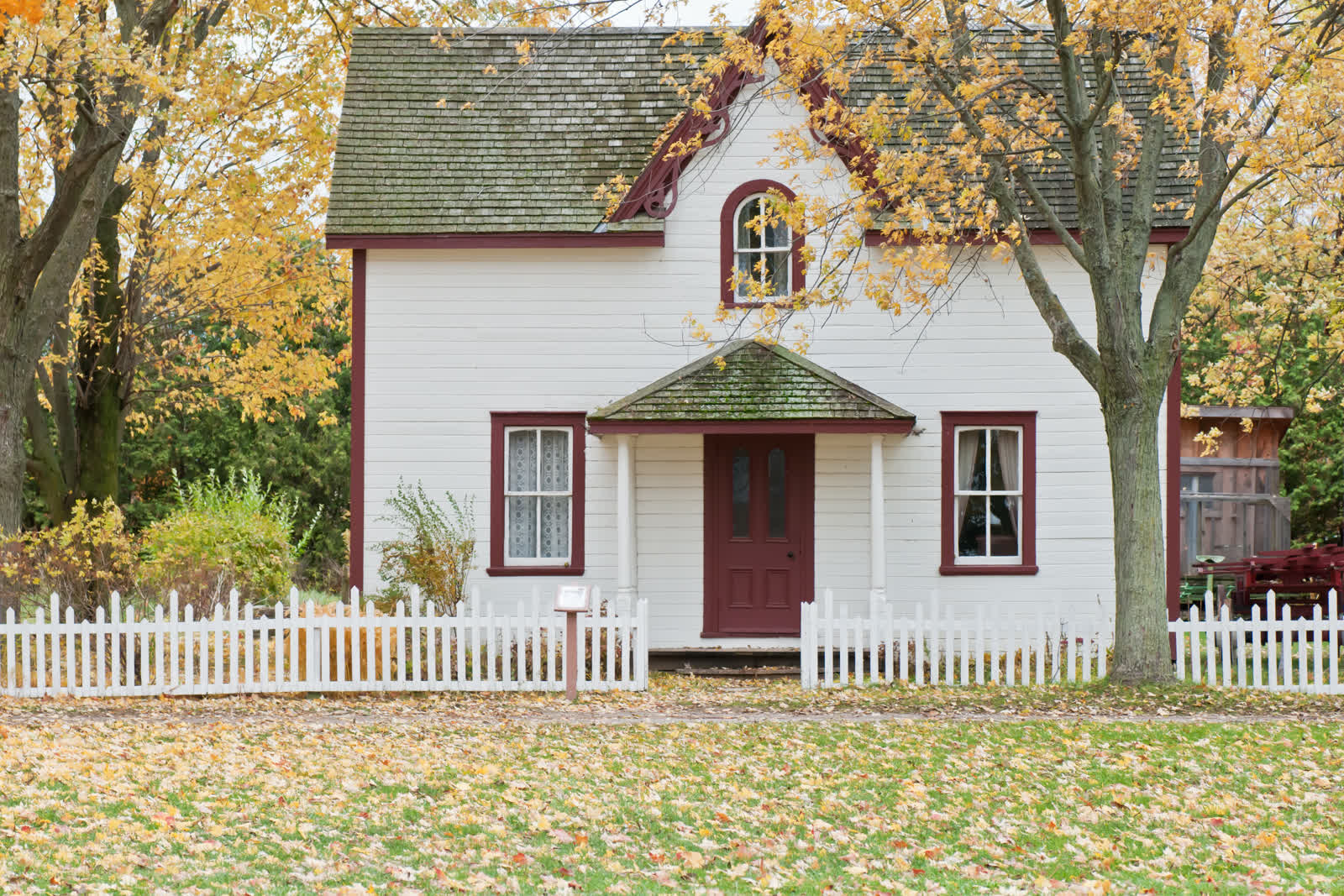 Heritage house surrounded by autumn trees in a Canadian rural region